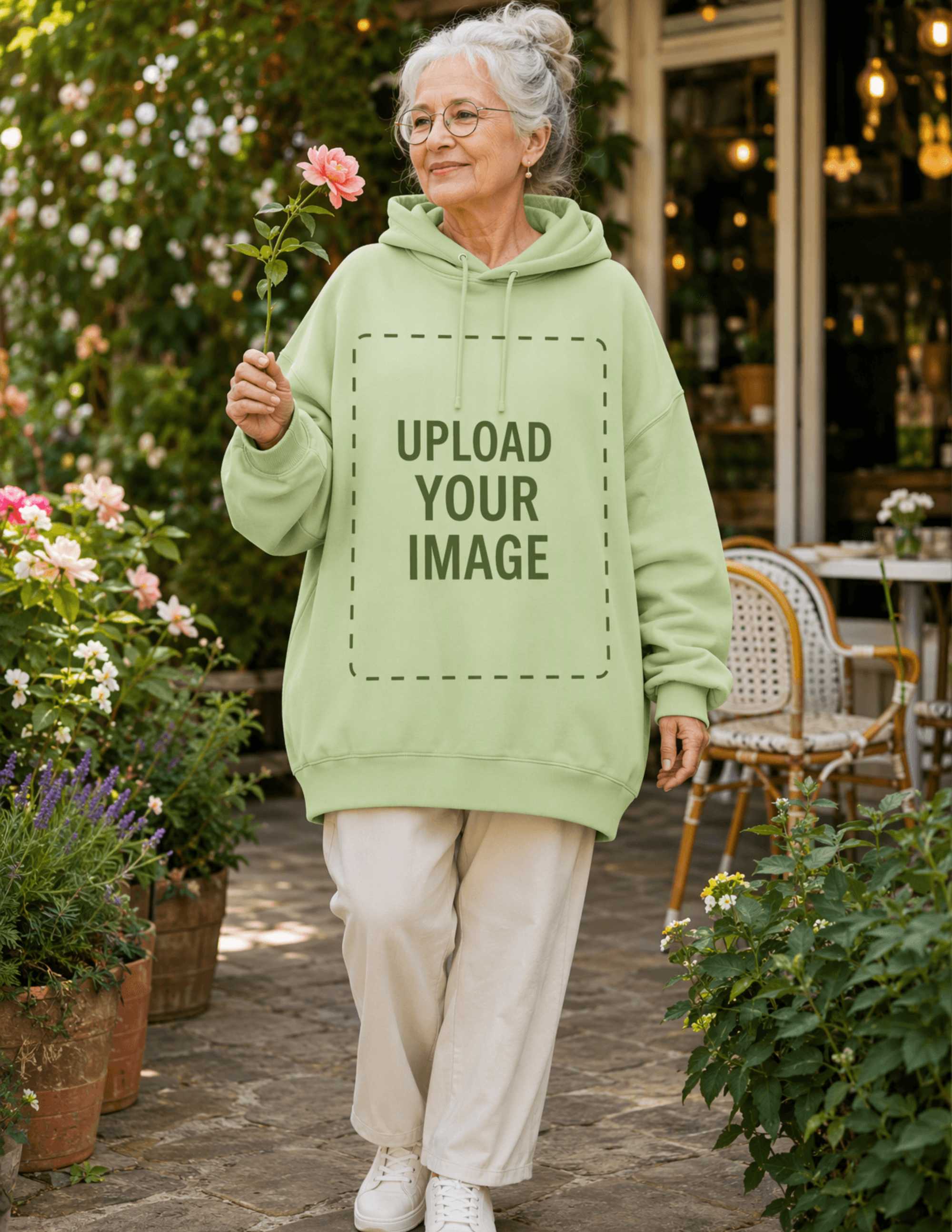 Free Senior Woman in a Garden with Oversize Hoodie Mockup Template to Edit Online