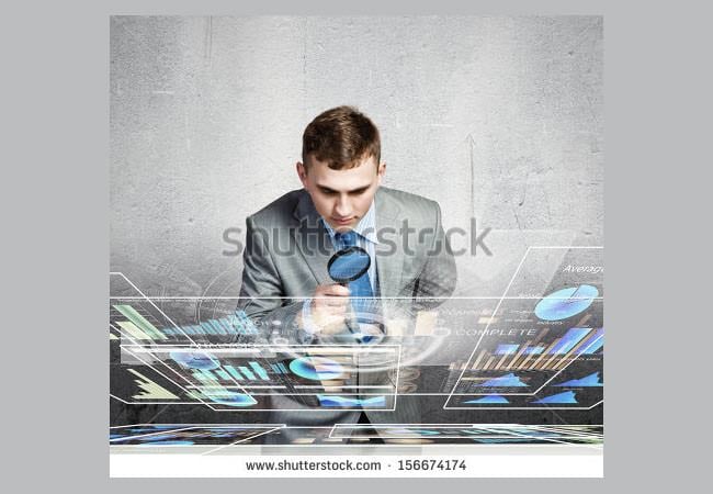 image of businessman examining objects with magnifier