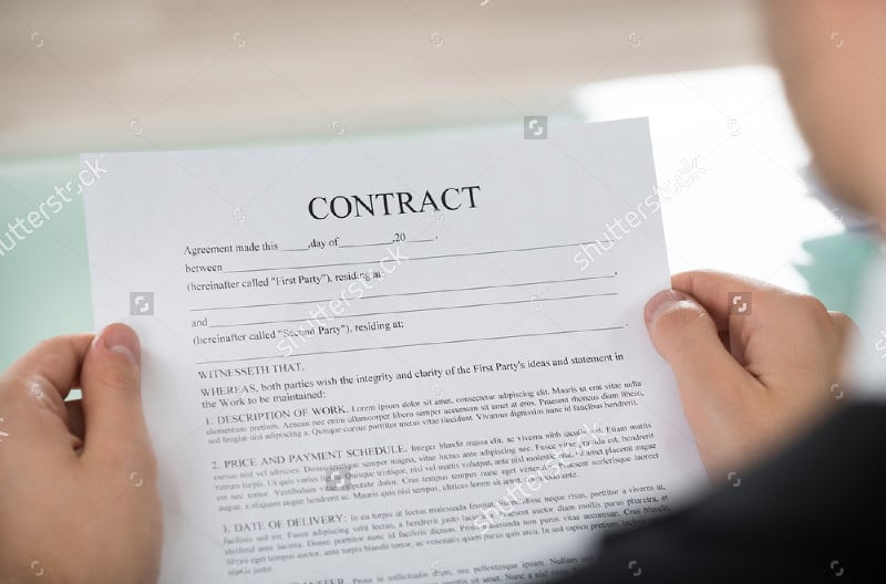 businessman hand holding contract form