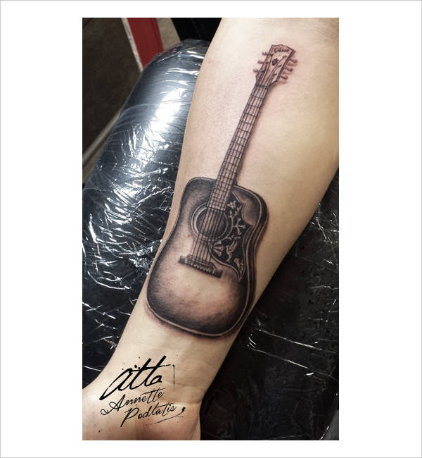 guitar forearm tattoo