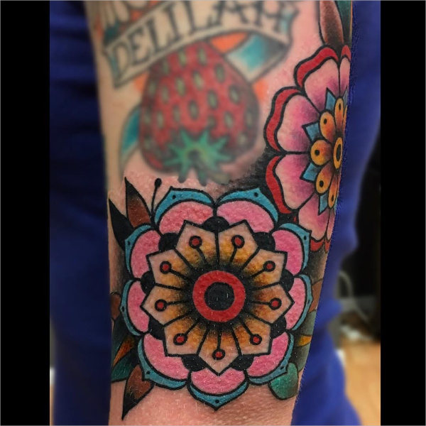 geometric flower tattoo on sleeve
